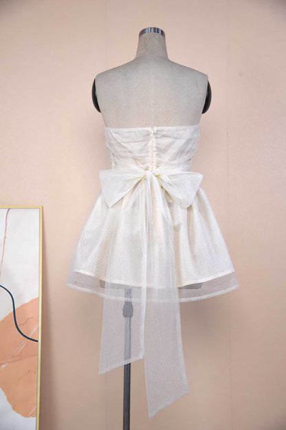 Back view of a Sparkle Strapless Mini Dress featuring a bow detail and delicate fabric
