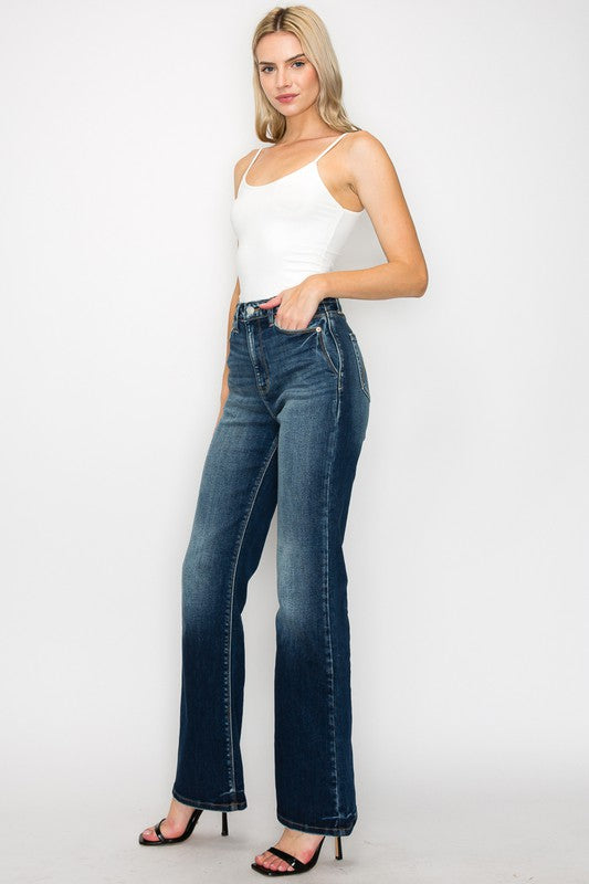 Artemis Vintage High Rise Holly Flare Jeans dark wash styled on model wearing white tank top and black heels