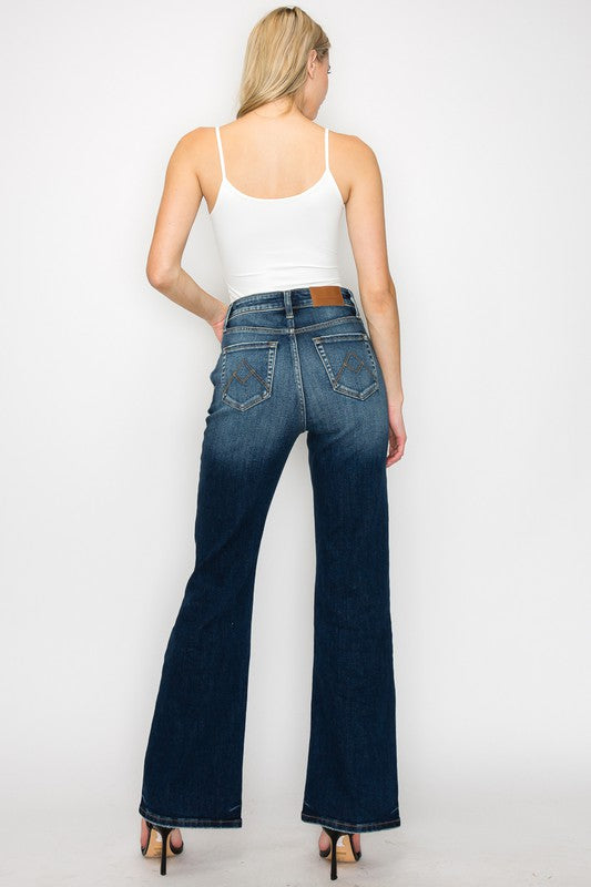 Artemis Vintage High Rise Holly Flare Jeans dark wash back view on model with white tank and heels