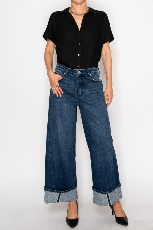 Artemis Vintage model wearing high rise wide leg jeans for women in dark indigo with cuff