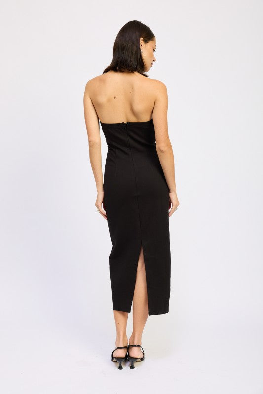 Emory Park model wearing a black open back midi dress strapless fitted silhouette with back slit