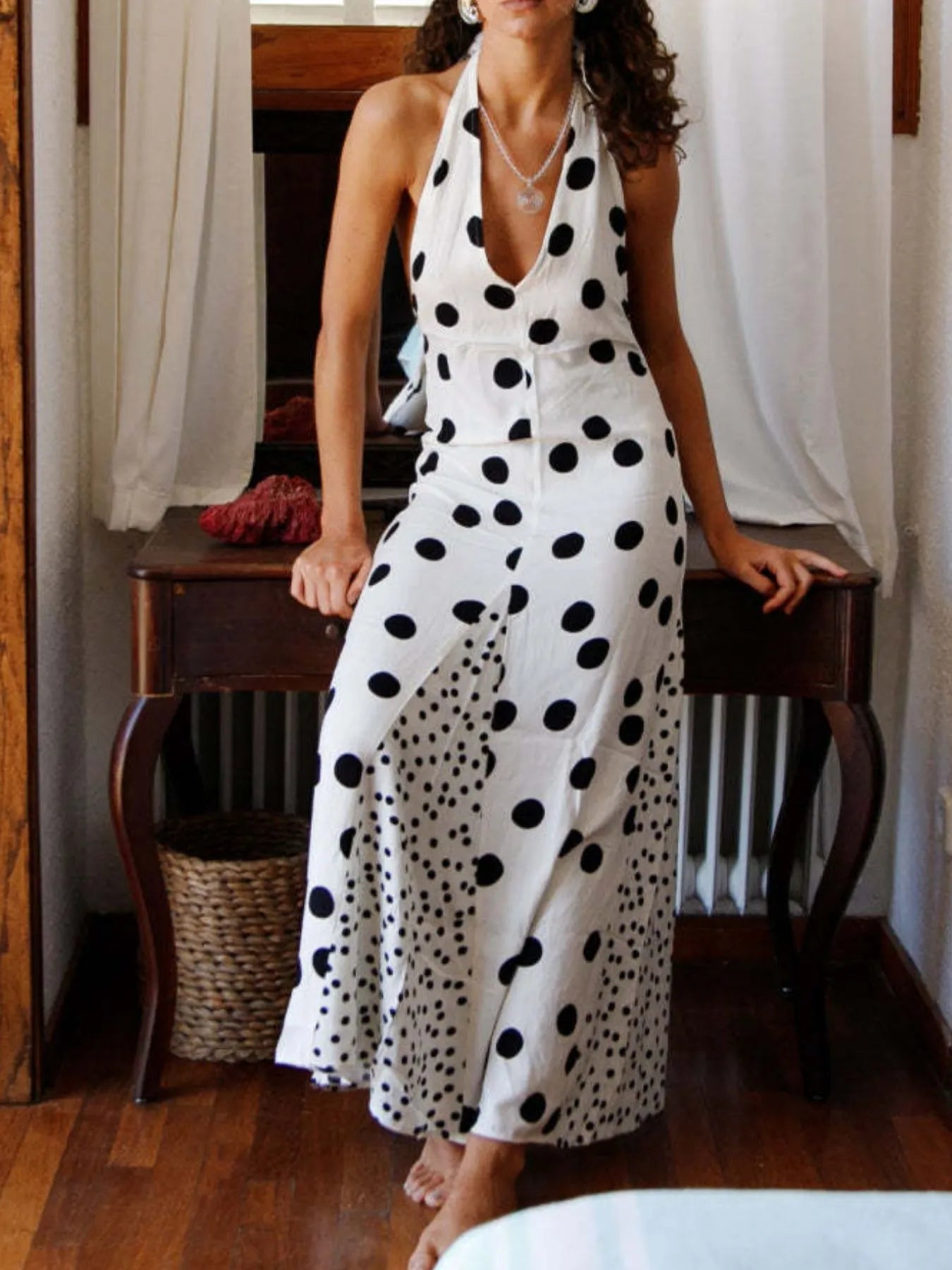 Polka Dot Maxi Dress halter V neck white with black dots fitted waist and front slit worn indoors
