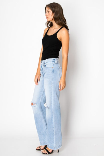 Artemis Vintage women's tummy control jeans light wash high rise wide leg with knee rips on model wearing black tank