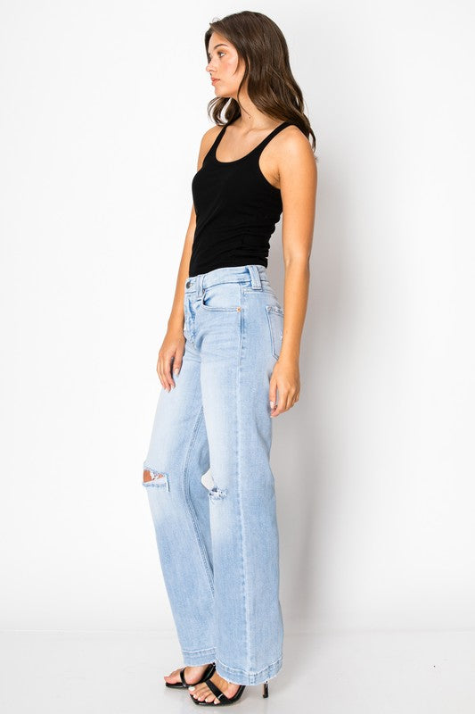 Artemis Vintage women's tummy control jeans light wash high rise wide leg with knee rips on model wearing black tank