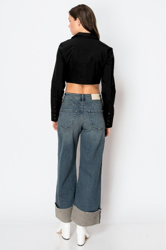 Artemis Vintage model back view wearing women's tummy control wide leg jeans with large cuff and white boots