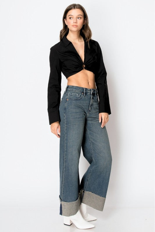 Artemis Vintage model wearing women's tummy control wide leg jeans with cuffed hems and white ankle boots