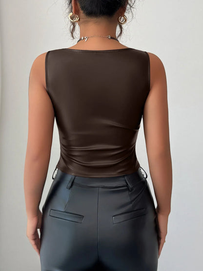 Back view of model wearing Trendsi women's faux leather tank top in chocolate brown paired with black faux leather pants