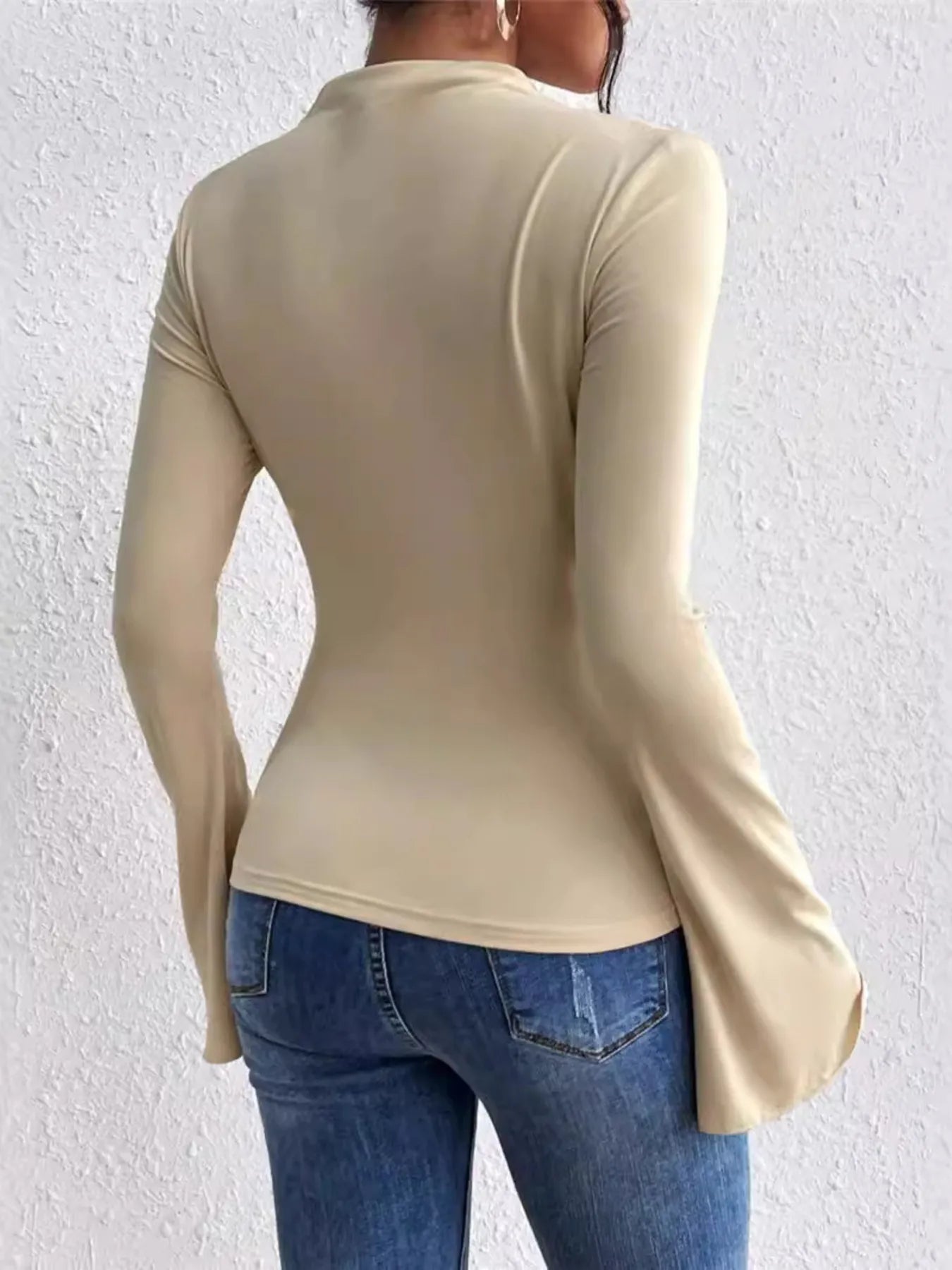 Trendsi beige long sleeve Fitted T-Shirt with flared cuffs shown from back styled with denim jeans