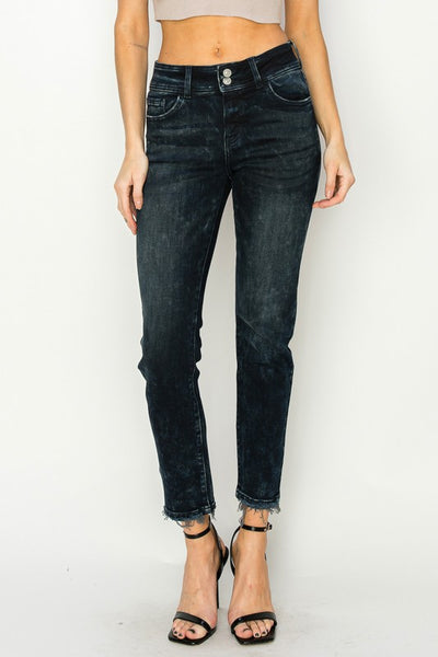 Artemis Vintage model wearing women's mid rise cigarette jeans in black wash with frayed ankle hems and double waist buttons