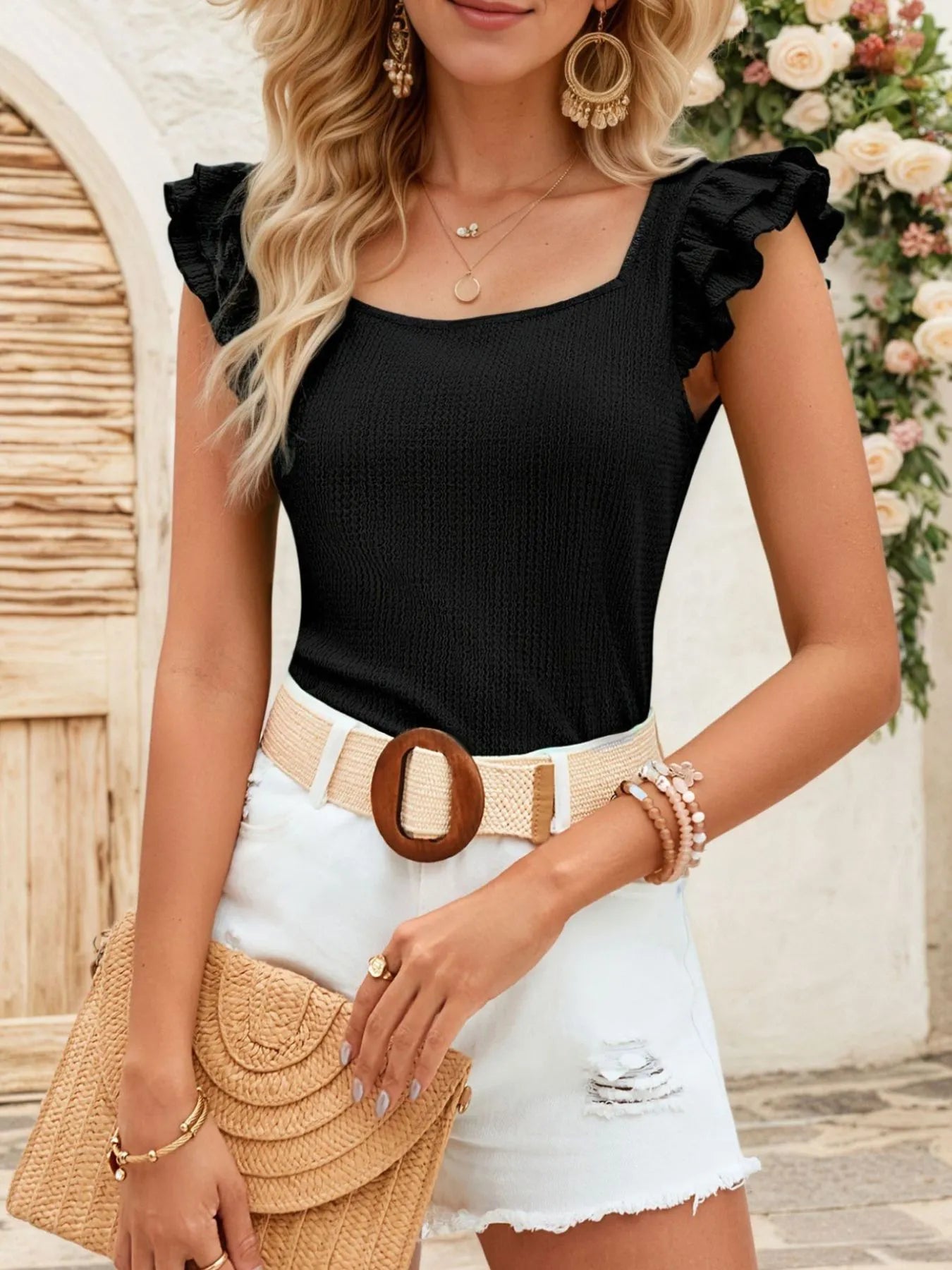 square neck ruffled cap sleeve top black knit paired with white distressed shorts straw belt and clutch