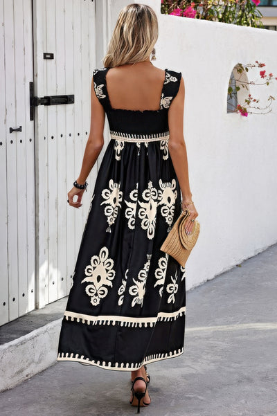 CCWHOLESALECLOTHING black maxi sleeveless square neck dress with white floral embroidery back view with straw clutch