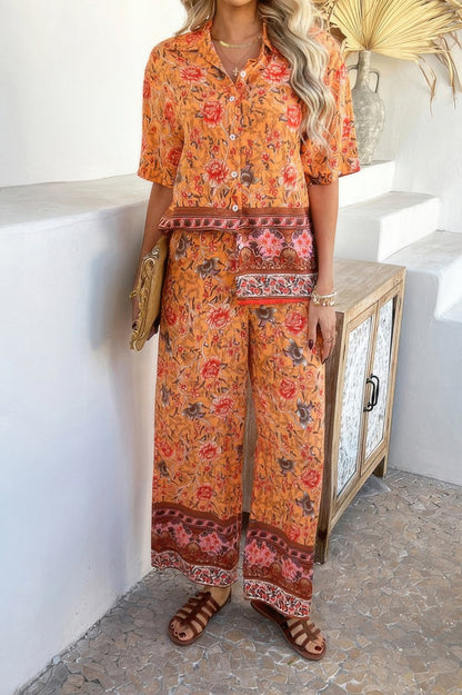 Woman wearing orange floral Boho Blouse Pant Sets with short sleeve button shirt and wide leg pants
