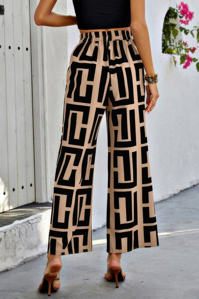 Back view of model wearing CCWHOLESALECLOTHING beige and black geometric print Wide Leg Loose Pants with elastic waist