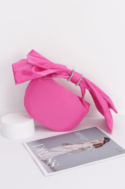 Fun Clutch Bag CCWHOLESALECLOTHING pink satin bow clutch with rhinestone ring detail on fashion magazine
