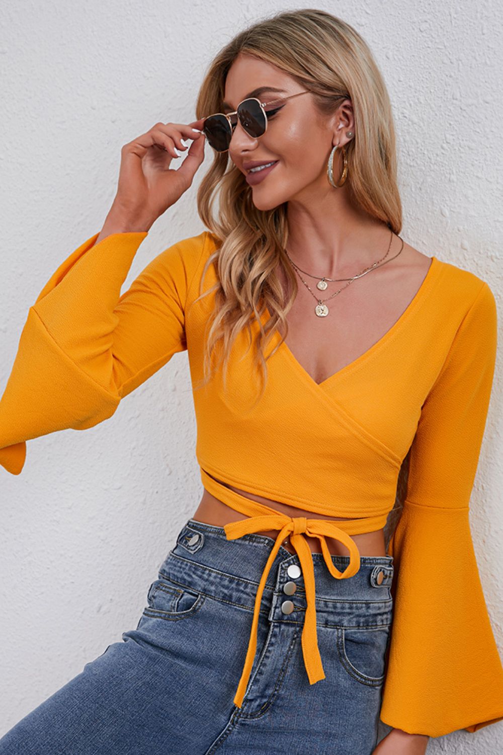 Trendsi Tie Front Cropped Top in vibrant yellow with bell sleeves and a flattering wrap design