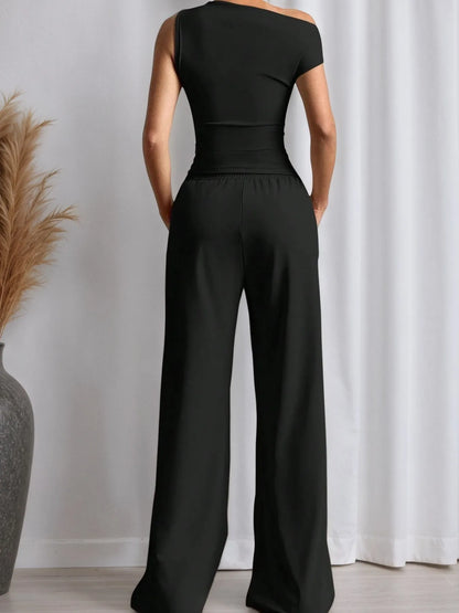 Stylish black top with trendy pants, showcasing a chic and comfortable outfit from Trendsi