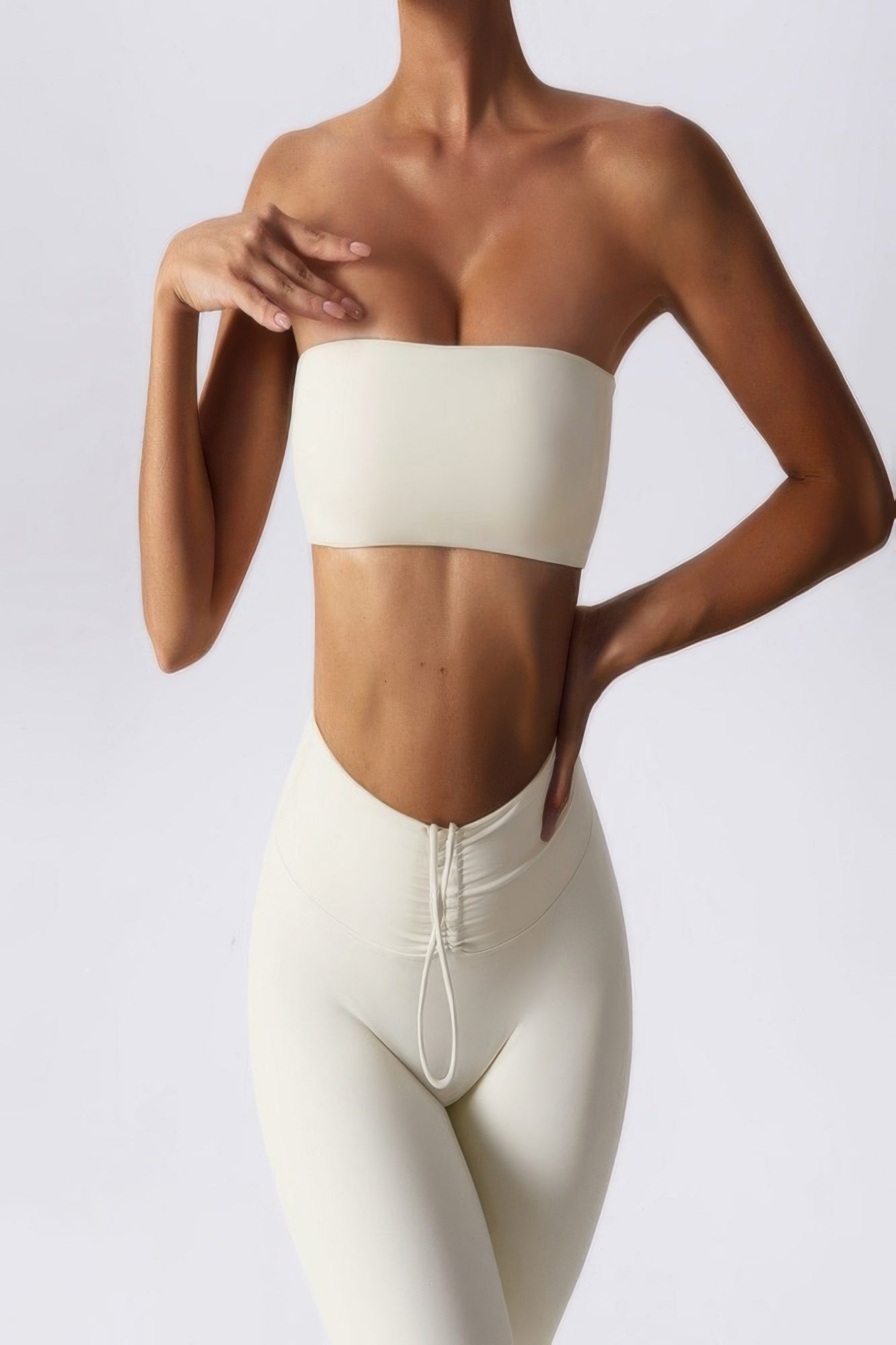 CCWHOLESALECLOTHING cream seamless strapless tube bra for women worn with matching high waisted leggings