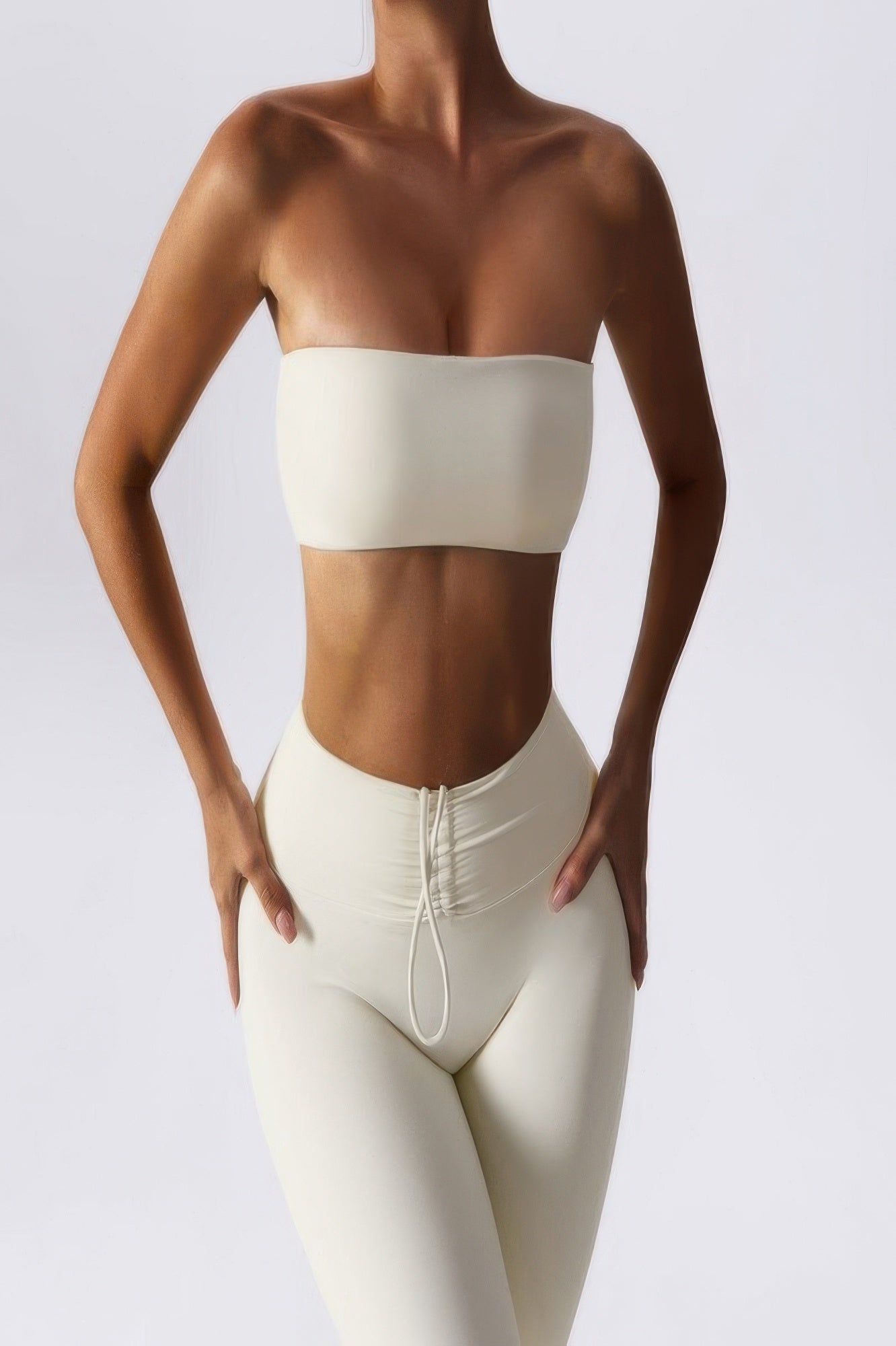 CCWHOLESALECLOTHING model wearing cream seamless strapless tube bra for women with high waisted leggings