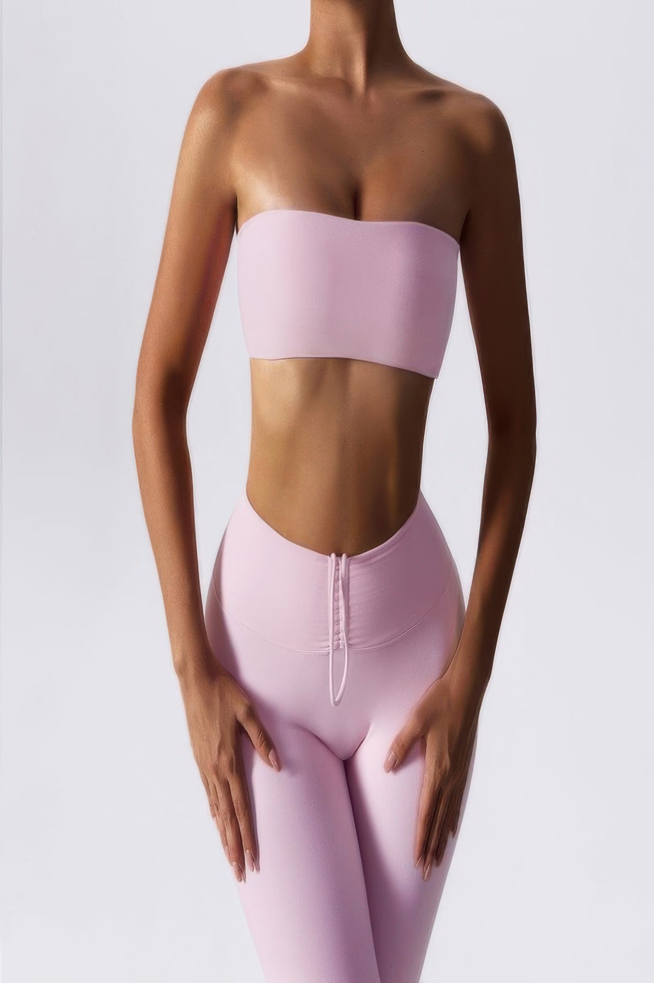 CCWHOLESALECLOTHING pink strapless tube bra for women styled with matching high waist leggings on model