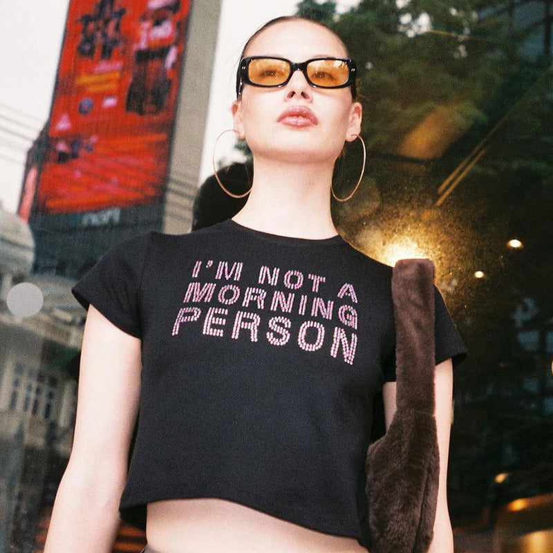 Trendsi model wearing black Crop T-Shirt with IM NOT A MORNING PERSON rhinestone slogan and sunglasses