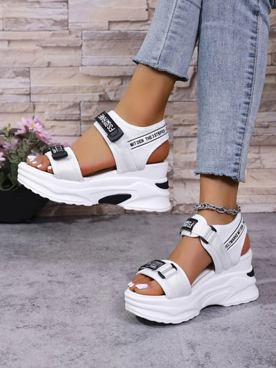 White chunky Platform Sport Sandals with adjustable velcro straps black logo on model wearing cropped jeans and ankle chain