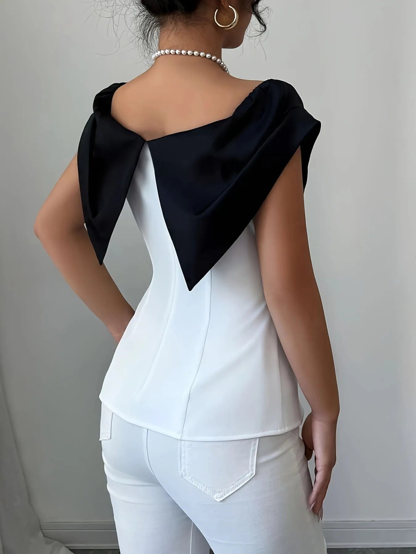 Trendsi apparel featuring a white top with a black Slit Contrast Color Cap design on the back