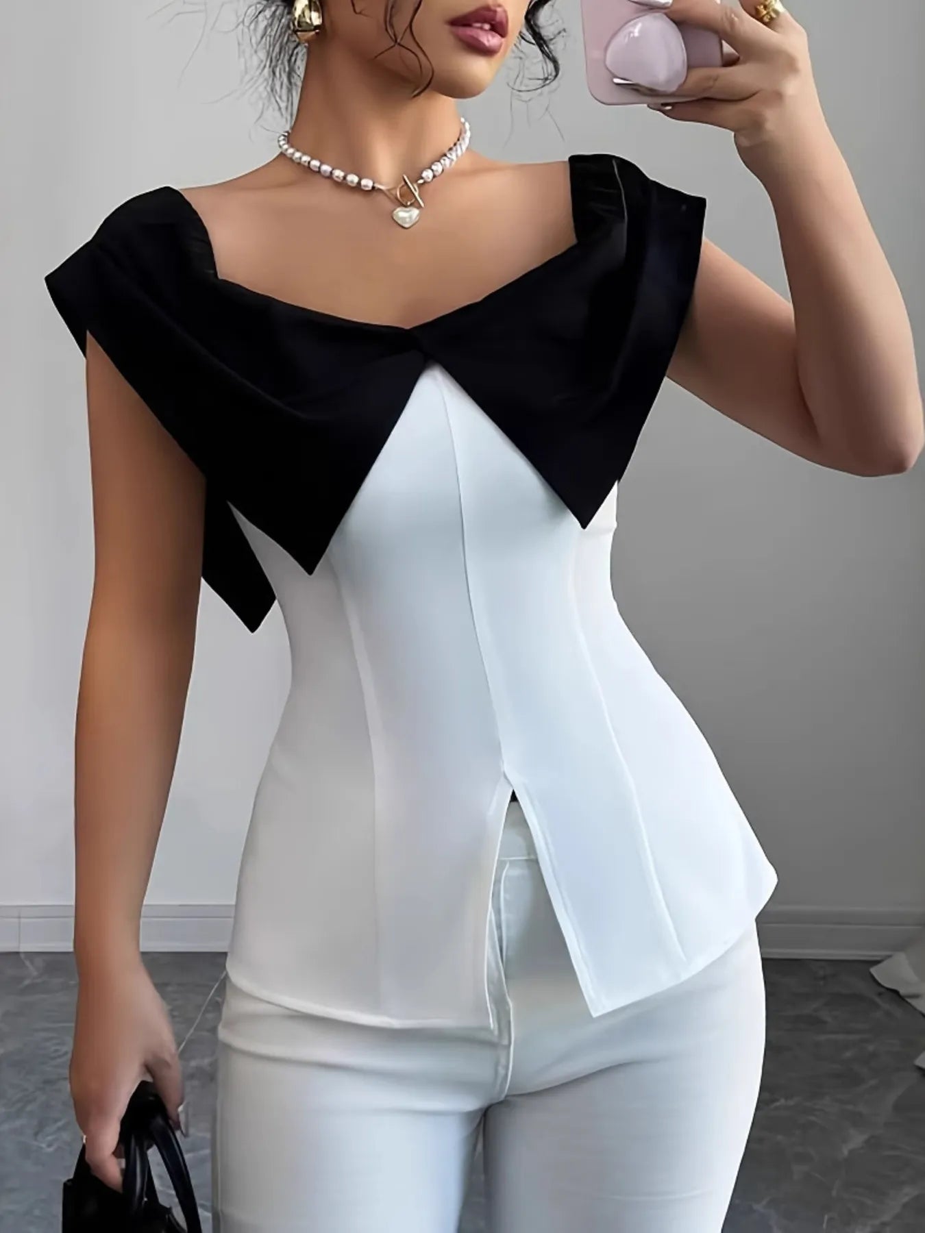 Trendsi white top with black collar featuring slit contrast color cap design and sleeveless style