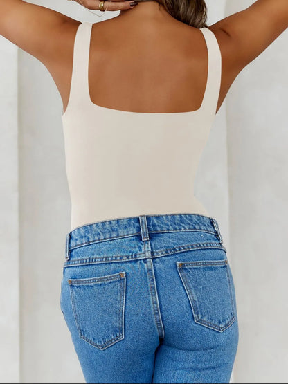 Trendsi V-Neck Tank Top in beige displayed on a model with light blue high-waisted jeans