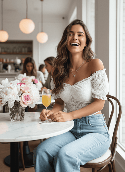 Woman wearing a Lace Crop Top with puff sleeves, sitting at a café table with a drink and flowers