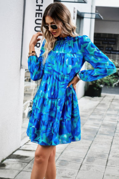 CCWHOLESALECLOTHING blue long sleeve abstract print tiered dress on model outdoors