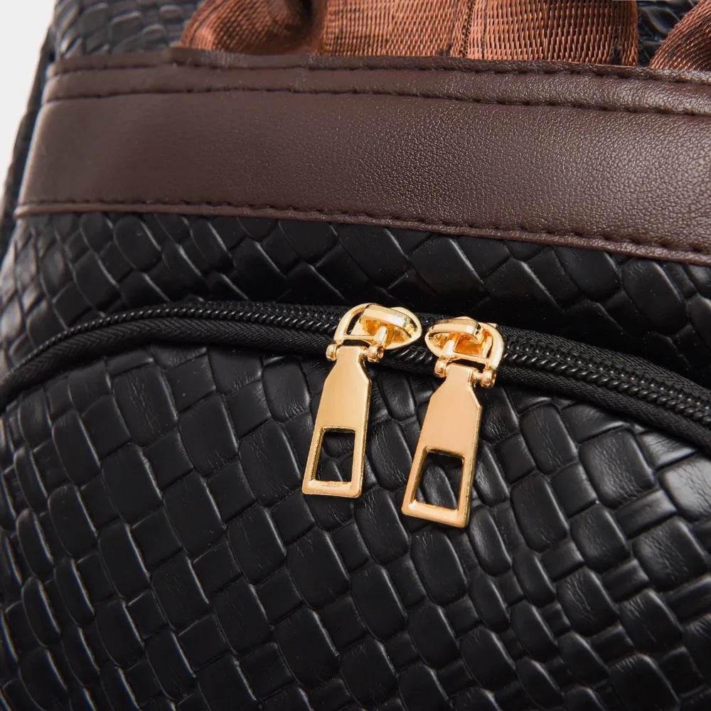 Close-up of a Woven Backpack Handbag featuring a textured black exterior and dual gold zippers