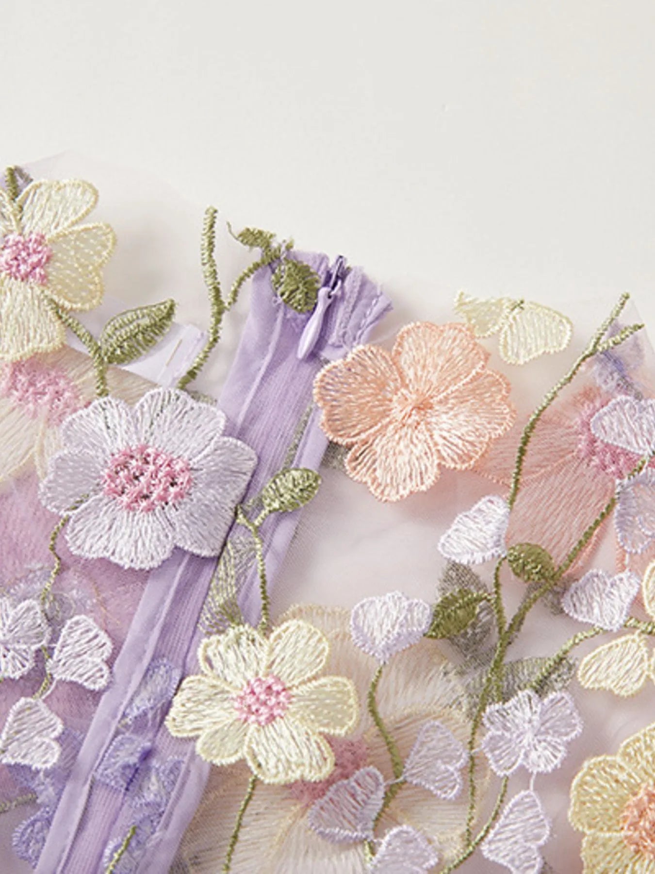 Trendsi Lined Evening Gown close up of pastel floral embroidered tulle overlay with lavender lining and invisible zipper