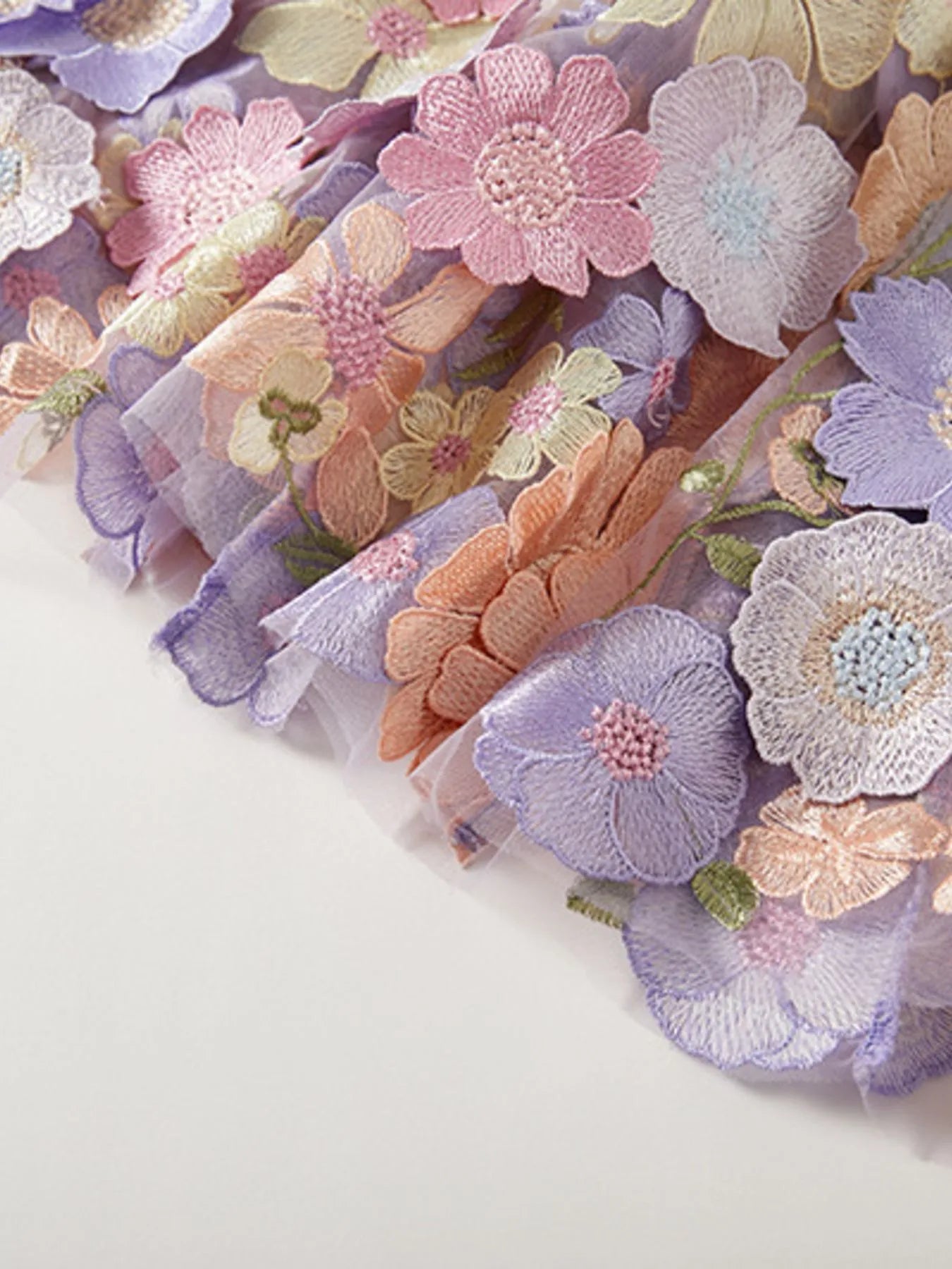 Trendsi embroidered pastel floral tulle hem detail on Lined Evening Gown showcasing layered applique and delicate scalloped edge